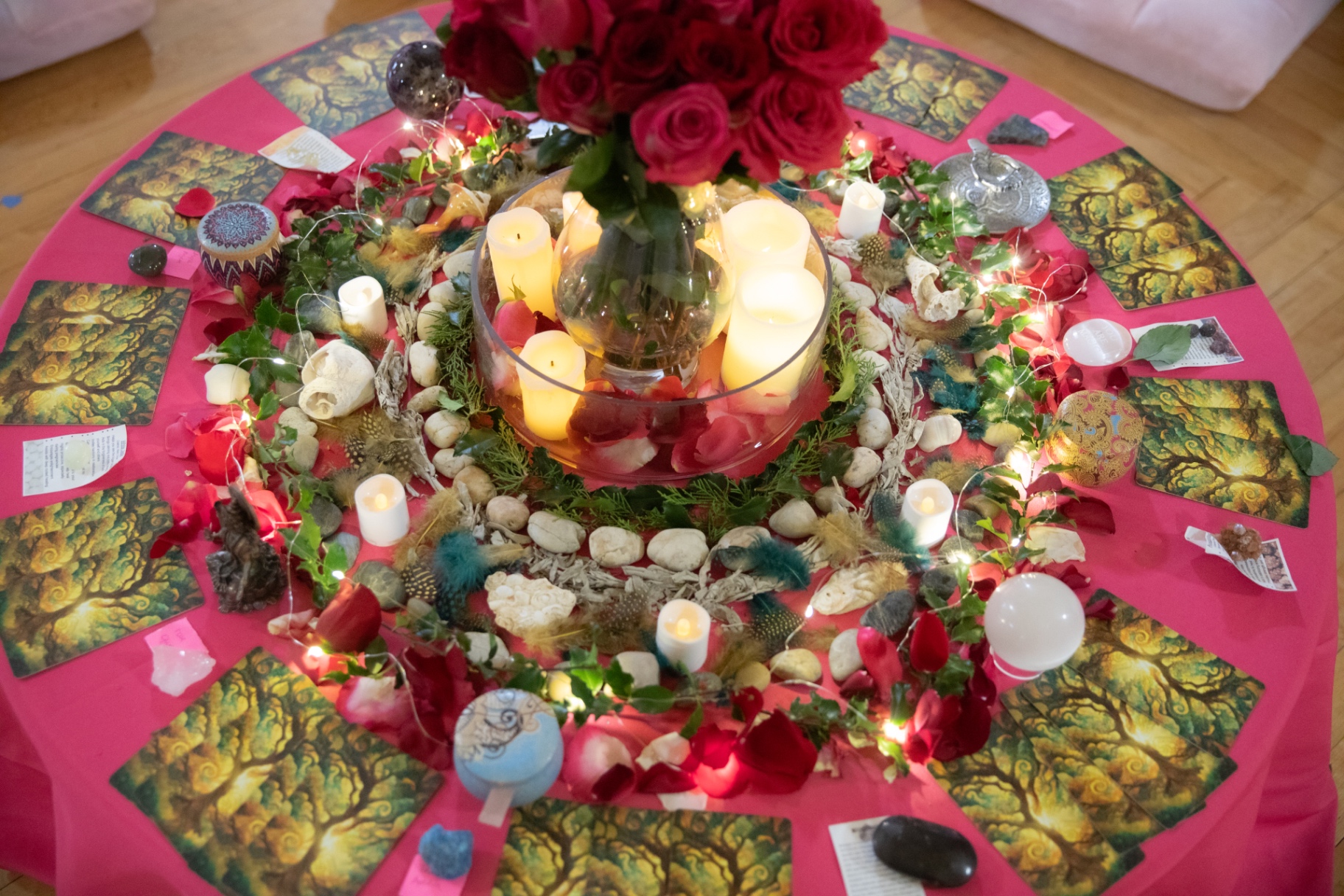 Close-up of the sacred altar with roses, crystals, candles and oracle cards